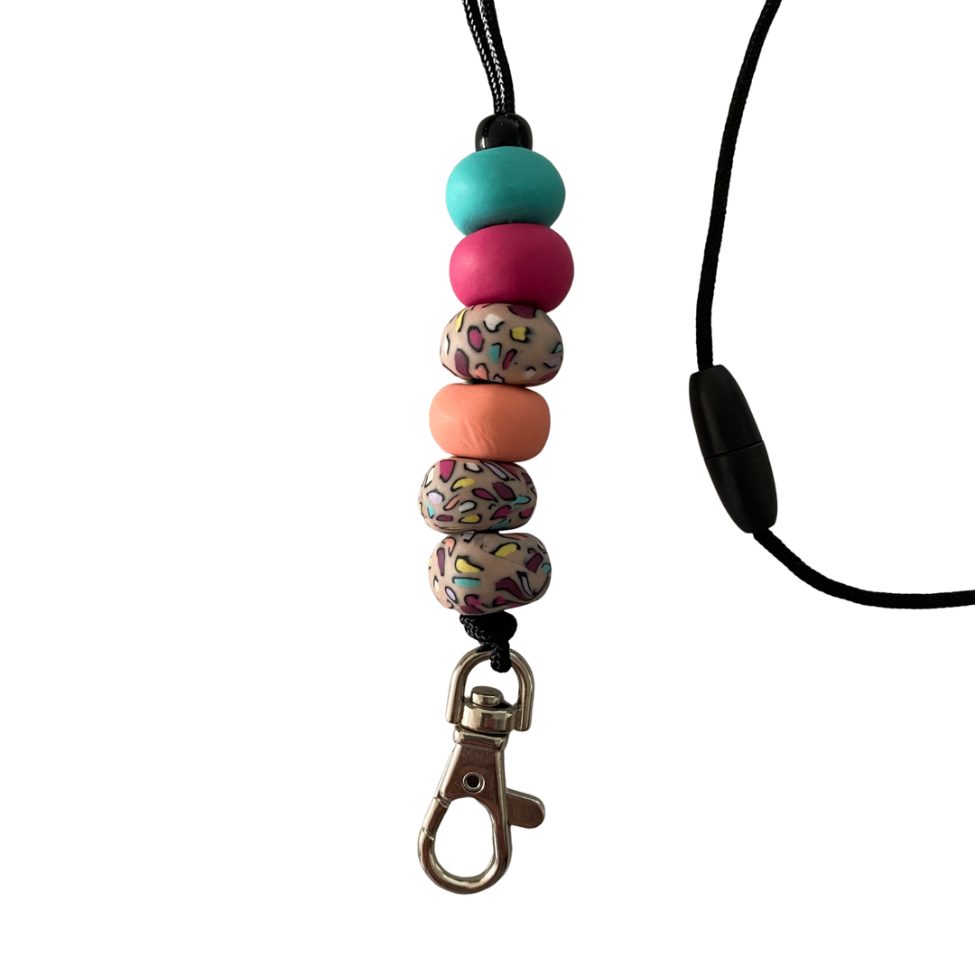 Handmade polymer clay lanyard with six hand-rolled beads in apricot, raspberry and turquoise palette with three vibrant, multicoloured beads.  Threaded on a nylon cord with a breakaway safety clasp and a silver-plated clip.