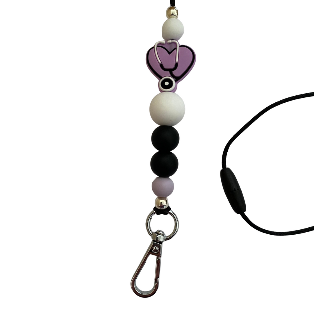 A 60cm lanyard fitted with a safety break away clasp and a Stethoscope Heart Lavender silicone bead and other coloured round silicone beads.