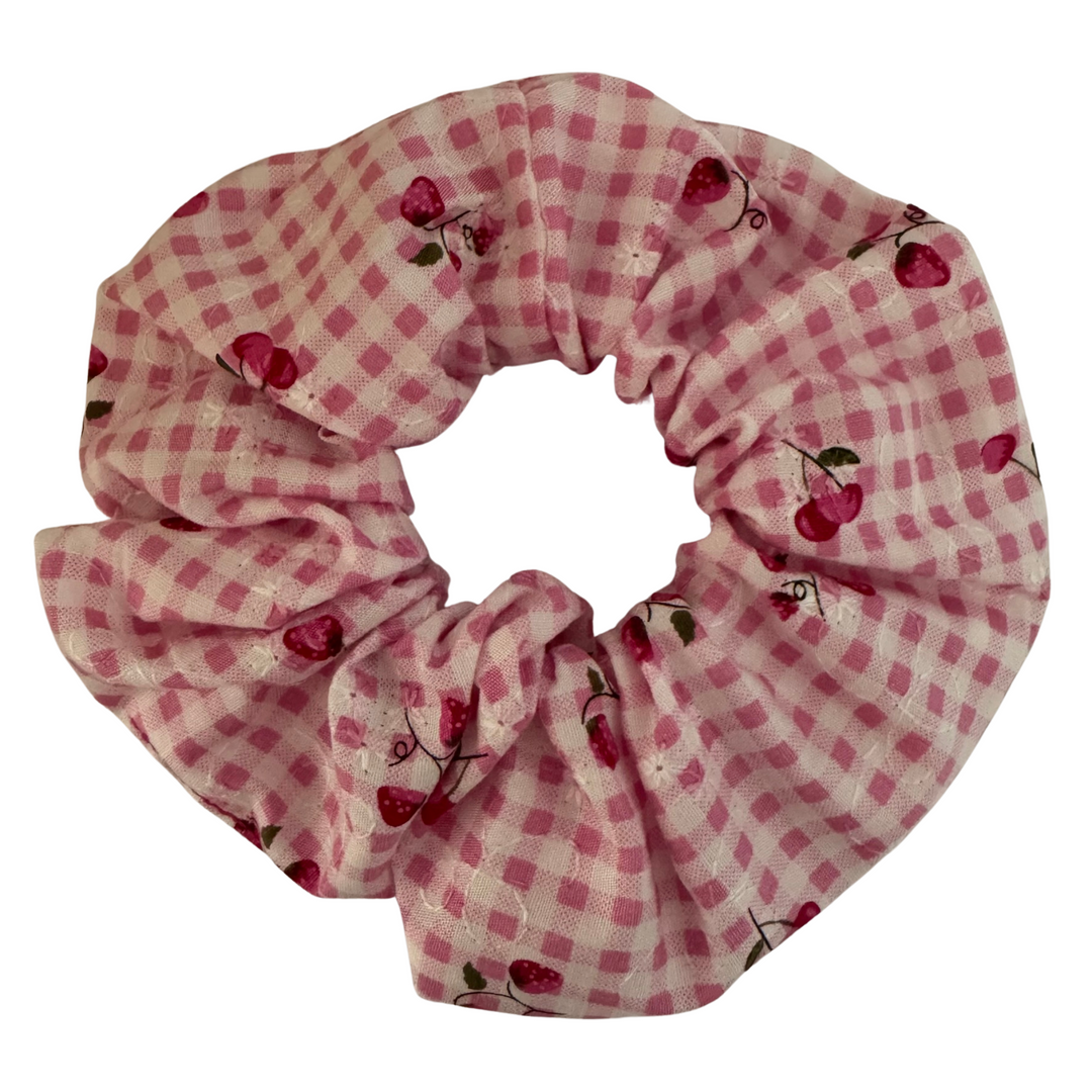 Strawberry Fields Pink Check Scrunchie featuring a sweet print of strawberries and cherries on a charming pink check background.