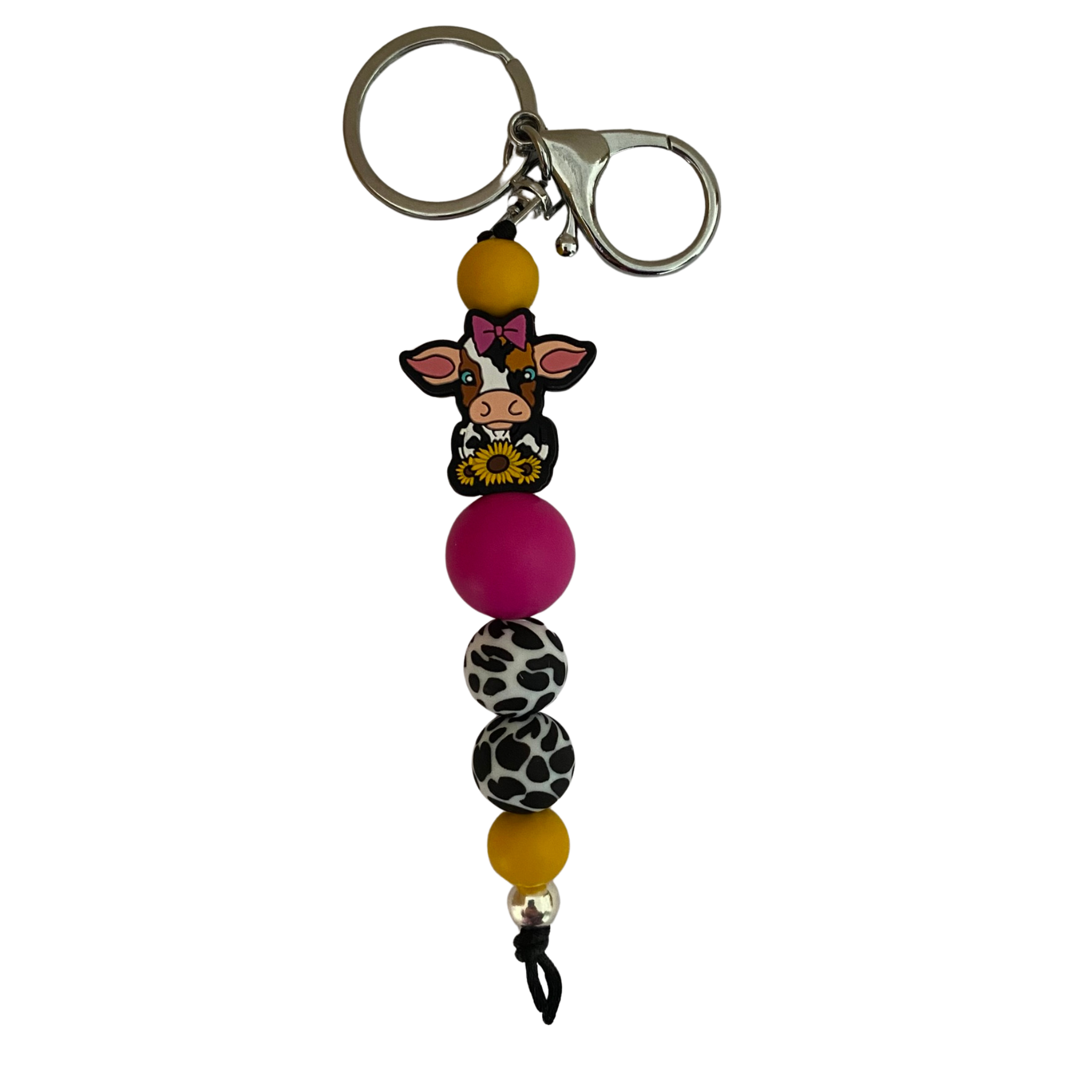 An 18cm keyring with a dairy cow wearing a pink bow and holding sunflowers silicone bead and other round coloured silicone beads.