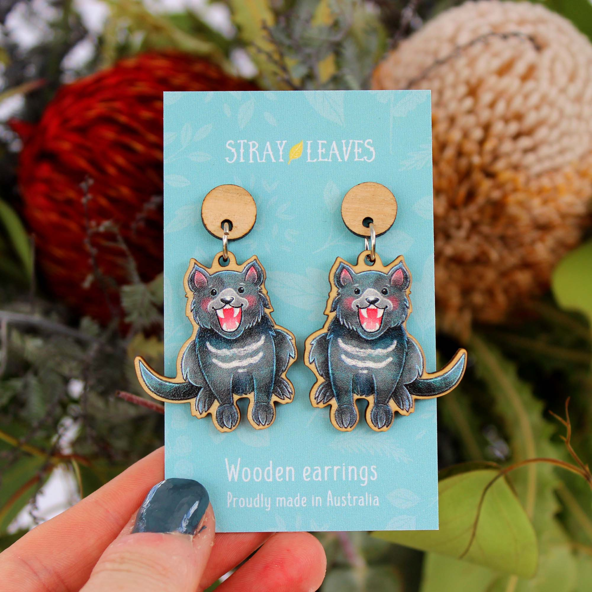 A picture of a pair of Tasmanian Devils on wooden dangle earrings.