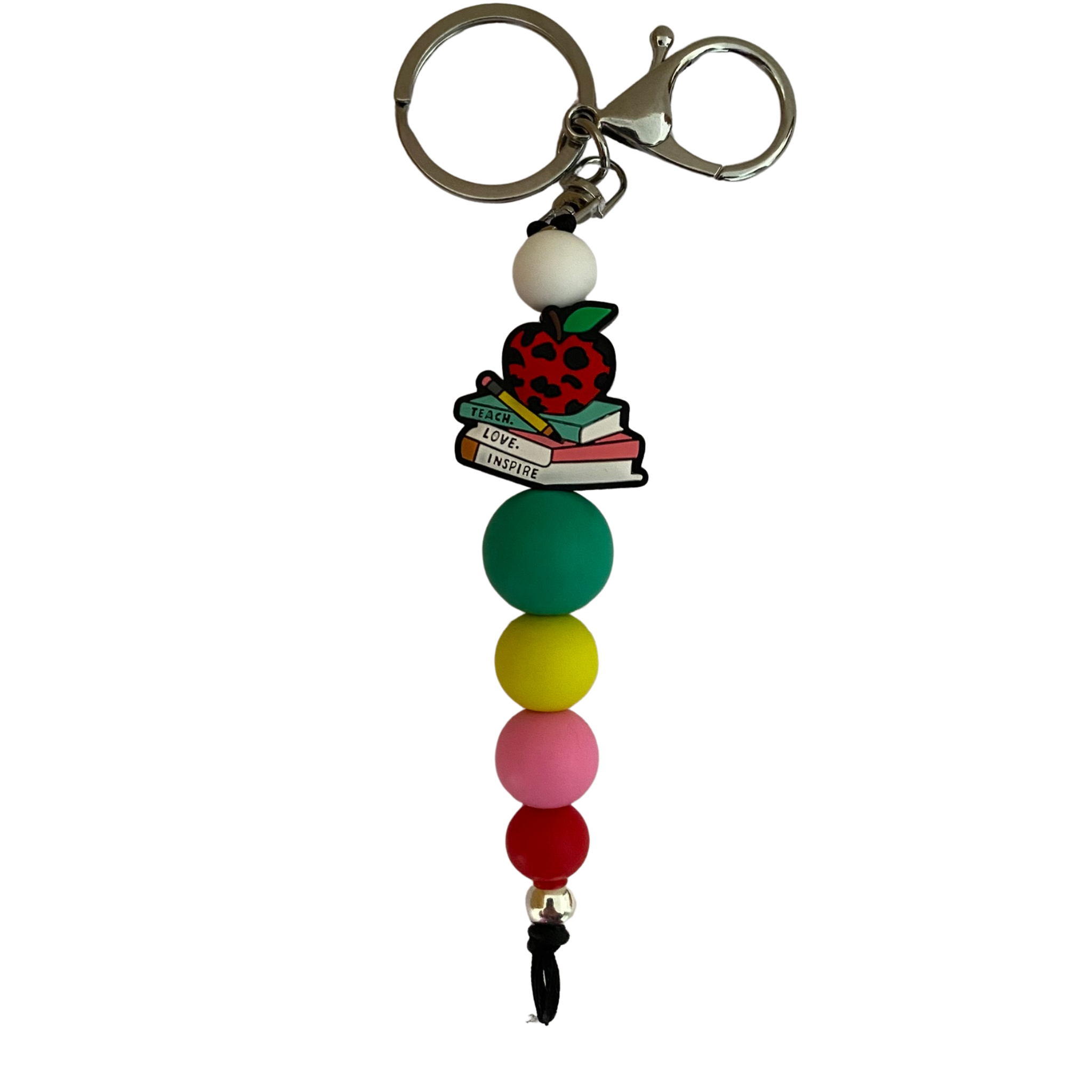 An 18cm keyring finished with a charming apple, pencil, and book stack charm engraved with the words Teach, Love, Inspire and other round coloured silicone beads.