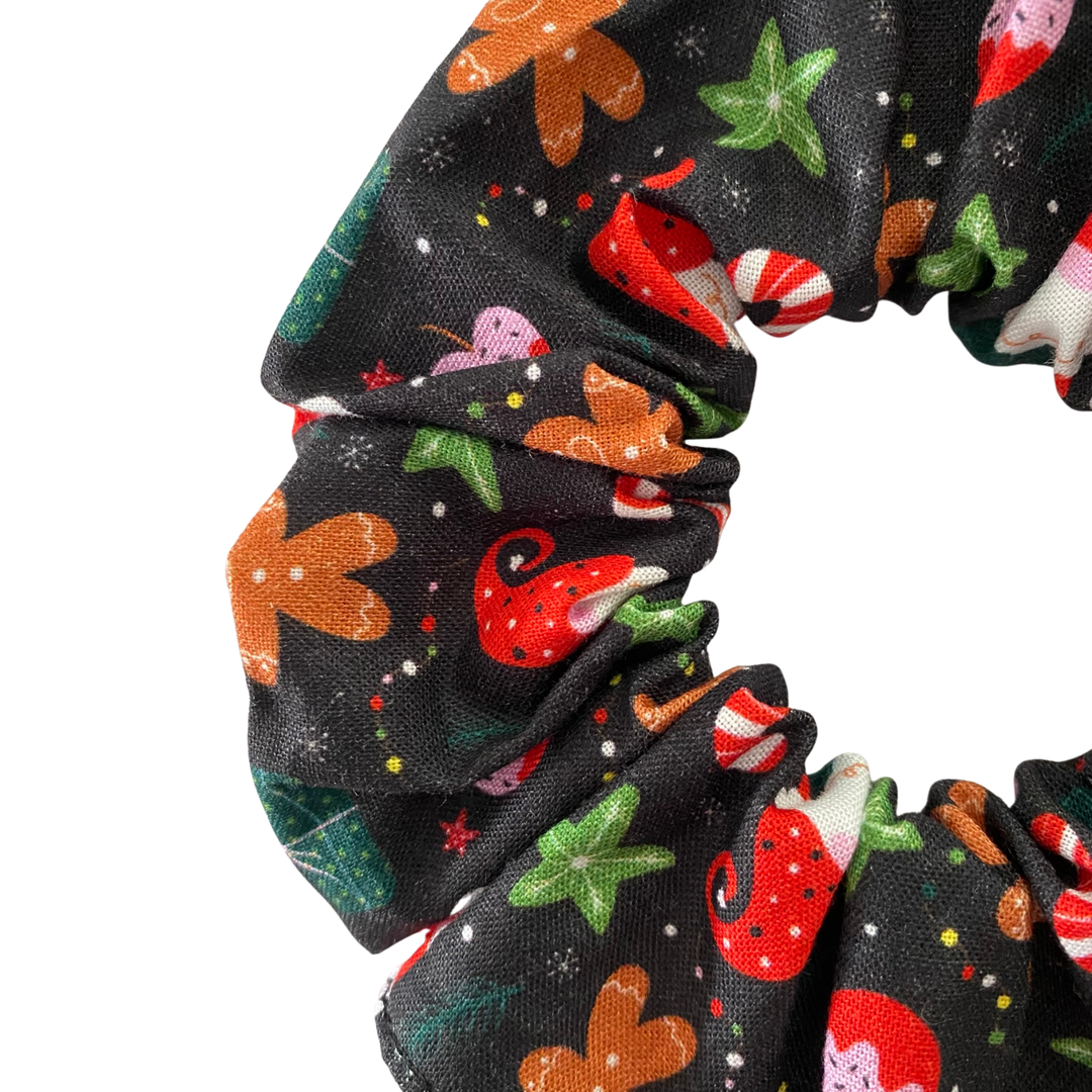 Scrunchie with Christmas-themed design on a black fabric.