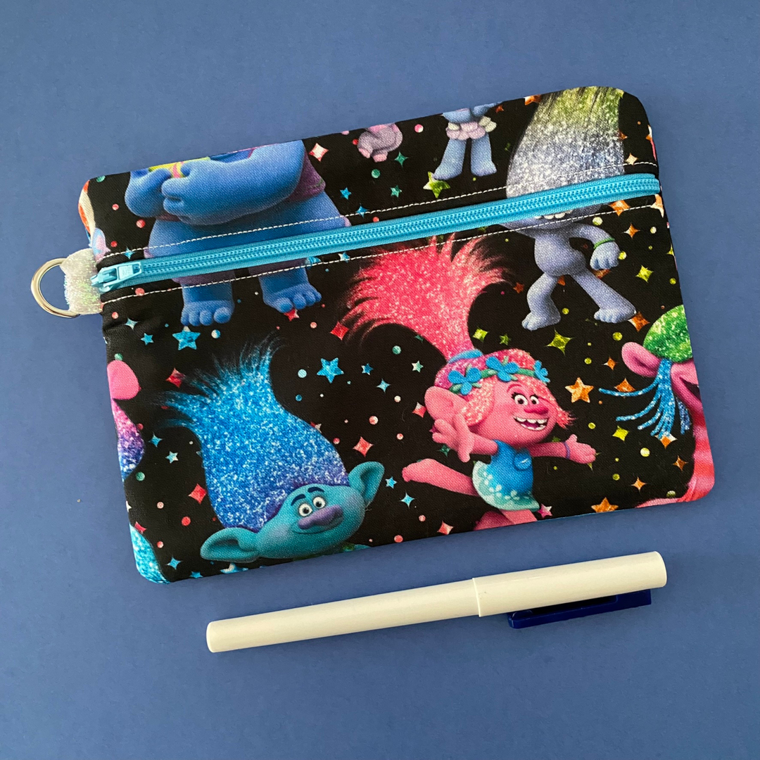 Zipper pouch with images of Trolls on black fabric. Planner accessory for school or work. Perfect for small essentials.