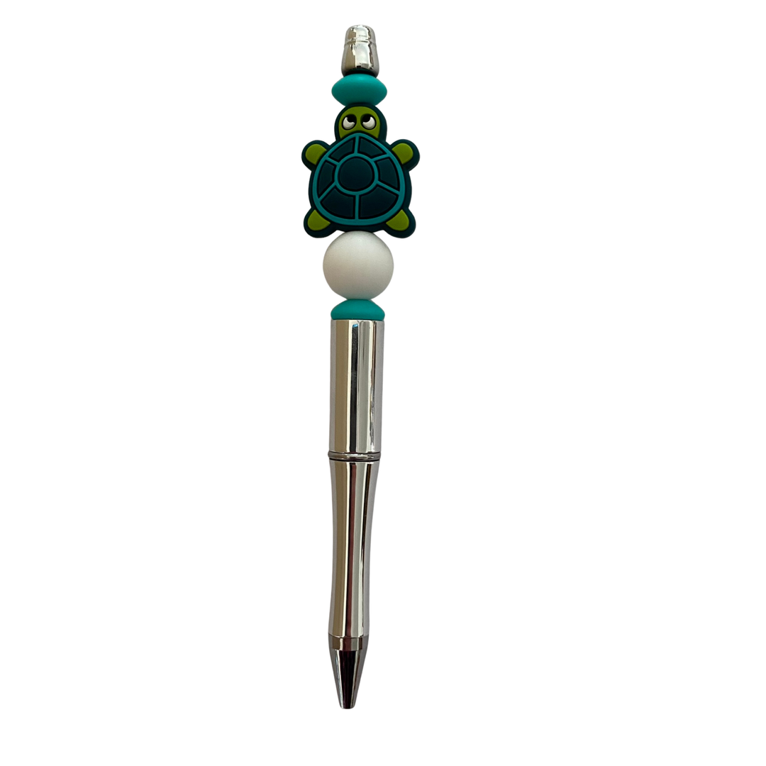 Pen with a turtle-shaped top on a white background.