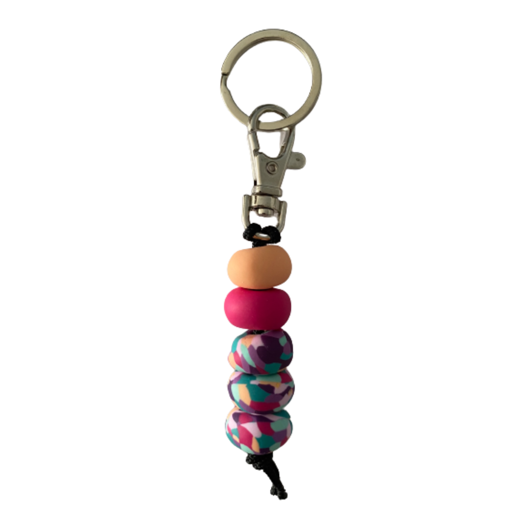 Handmade polymer clay keyring featuring five hand-rolled beads in apricot, raspberry, and multicoloured designs, attached to a silver clasp.