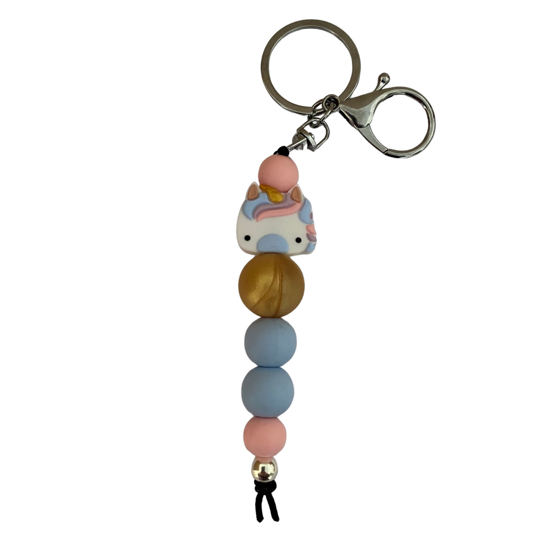 An 18cm keyring featuring a pastel blue unicorn head and other coloured round silicone beads.