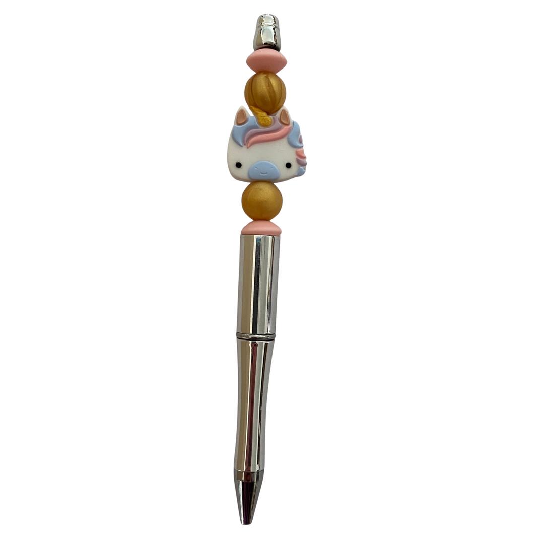 Pen with a unicorn pastel blue silicone bead on top on a white background.