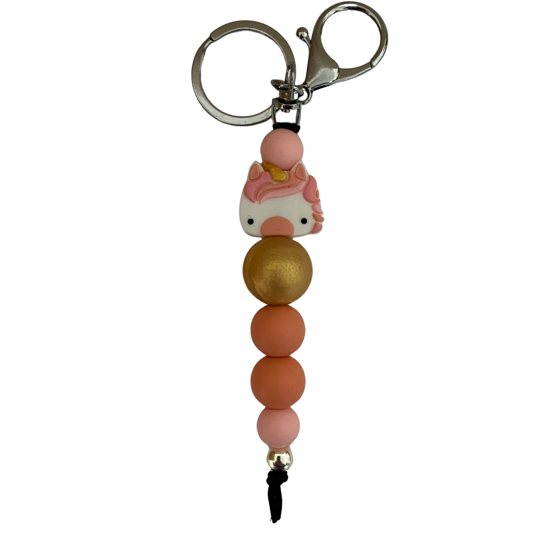 An 18cm keyring featuring a southern peach unicorn head and coloured round silicone beads.