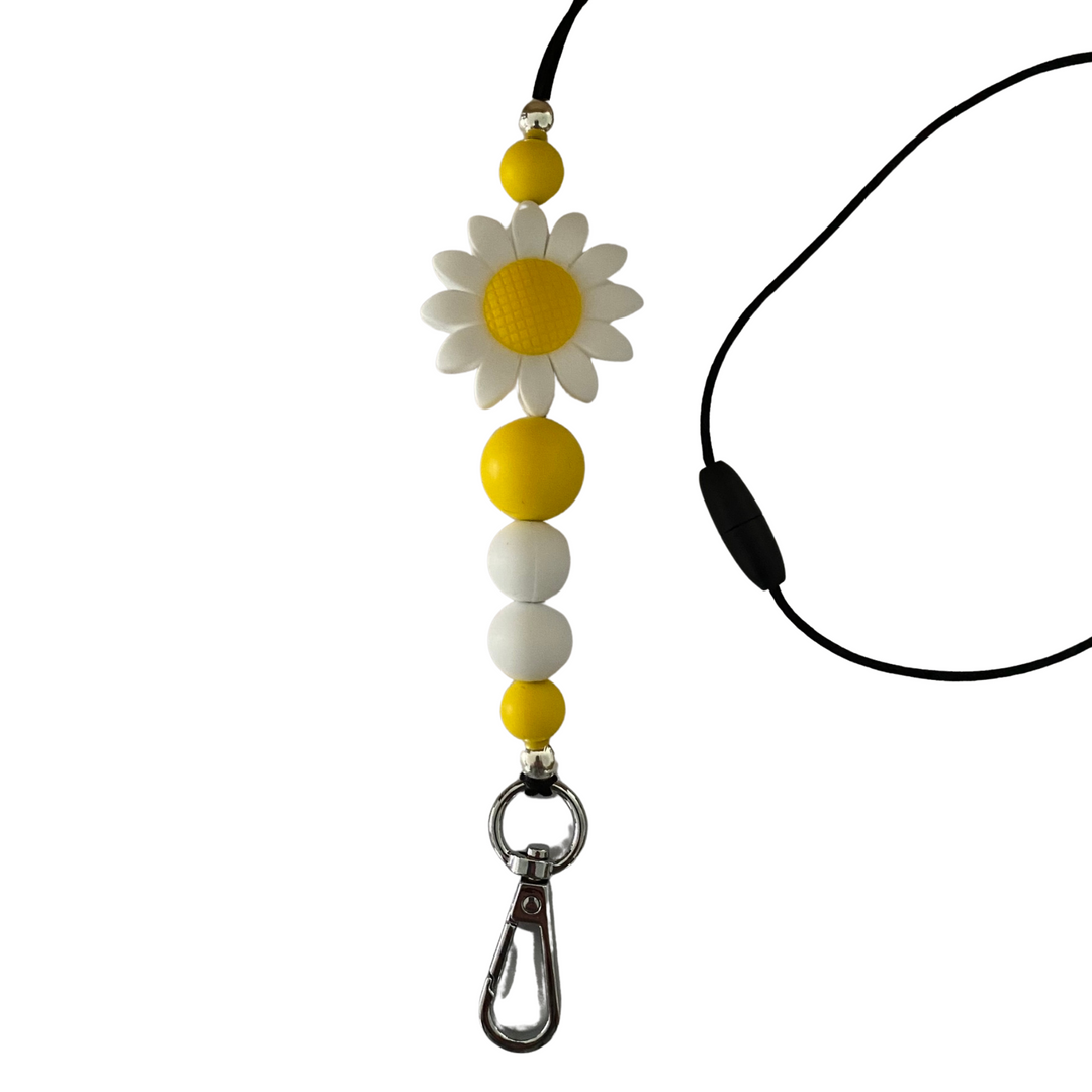 A 60cm black cord lanyard with breakaway clasp with a large white sunflower silicone bead and other coloured silicone beads.