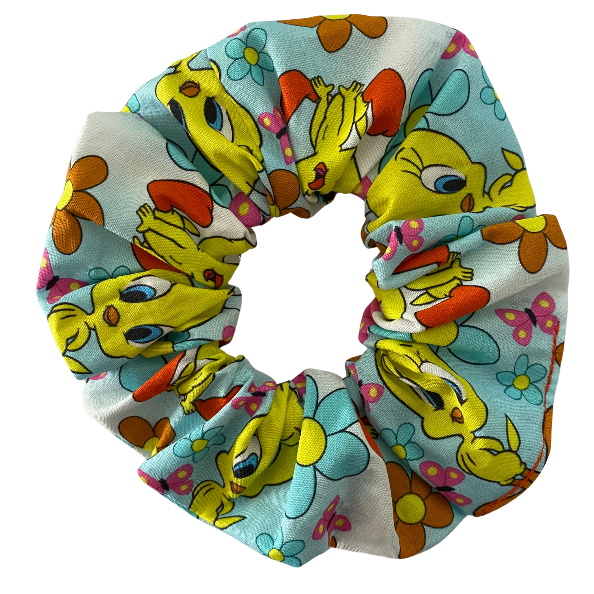 A scrunchie with images of Tweety Bird, flowers and butterflies on a light blue fabric.
